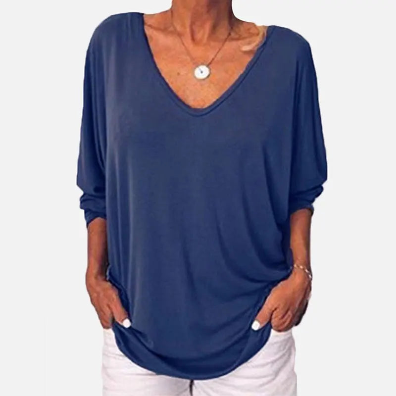 Woman wearing blue V-neck three-quarter sleeve top, front view