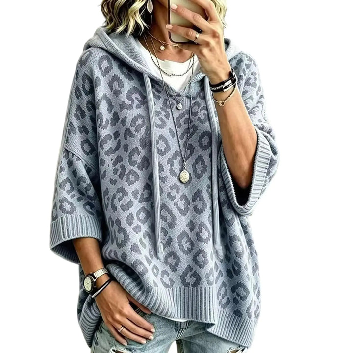 Woman wearing gray leopard print hooded pullover with batwing sleeves
