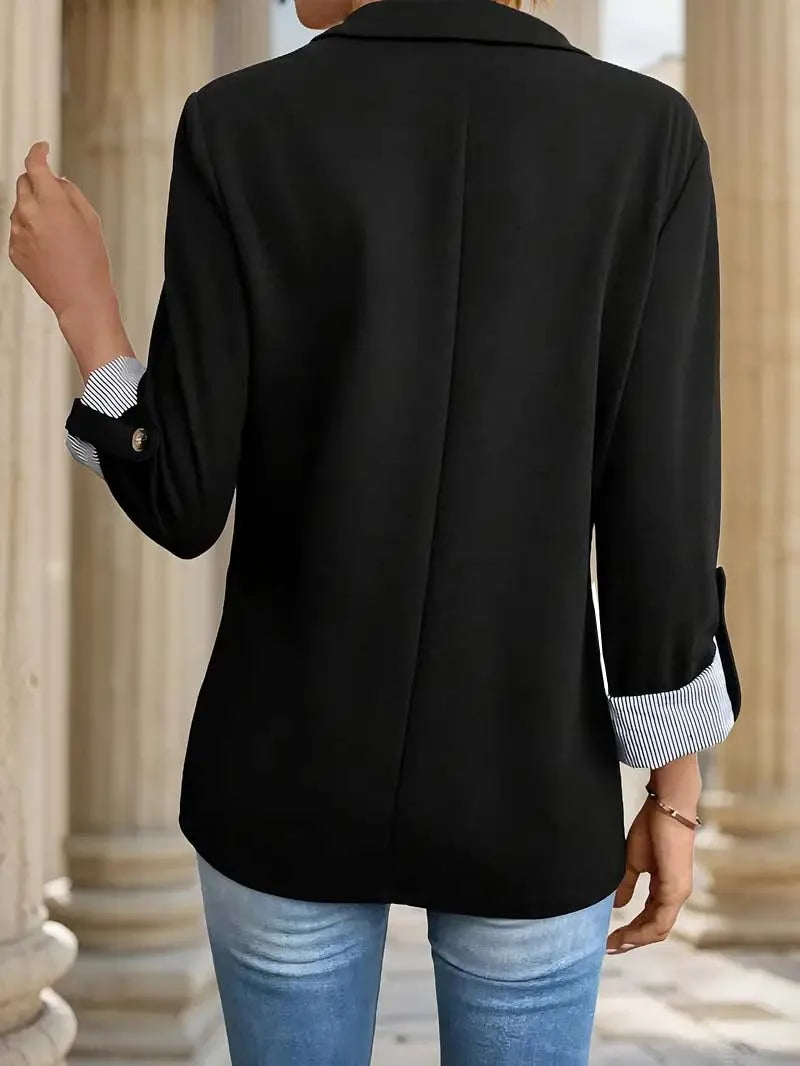 Black blazer back view with rolled striped cuffs