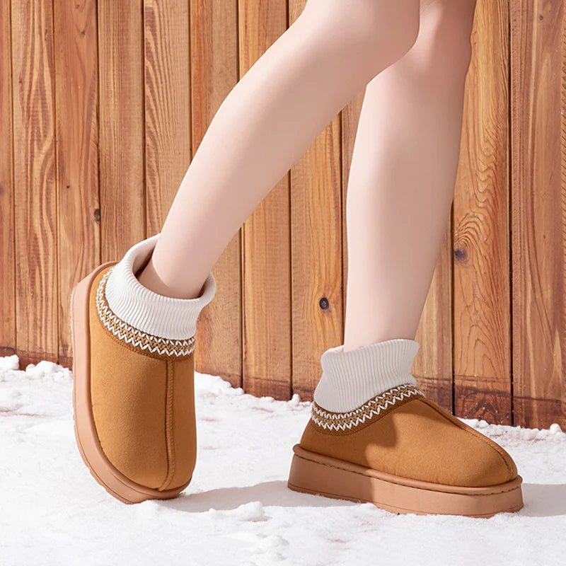 Brown plush ankle boots worn outdoors on snow