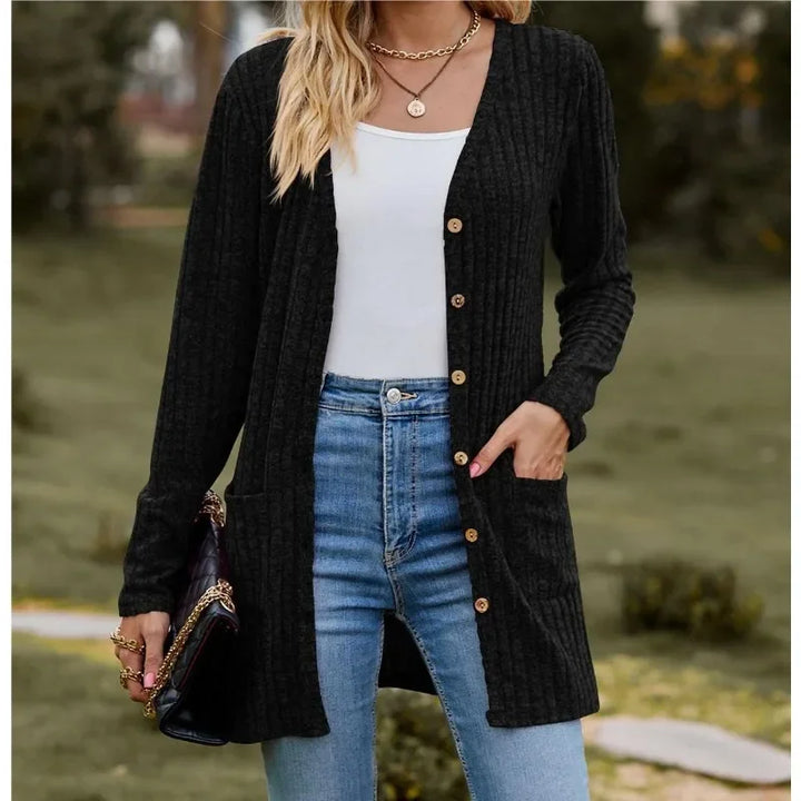 Woman wearing black ribbed knit open front cardigan with pockets
