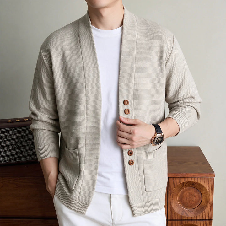 Man wearing beige knit shawl collar cardigan with patch pockets