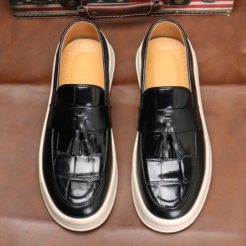 Pair of black tasseled loafers viewed from above