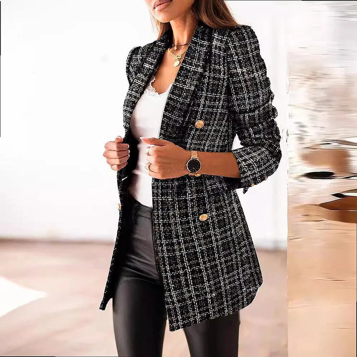 Woman wearing black and white tweed double breasted blazer