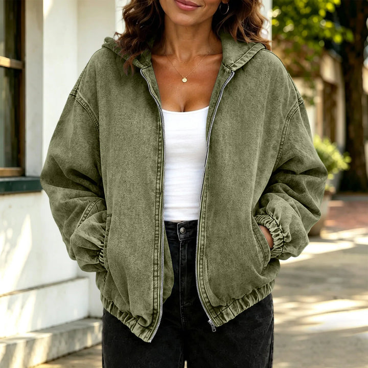 Woman wearing army green hooded denim jacket, close up view