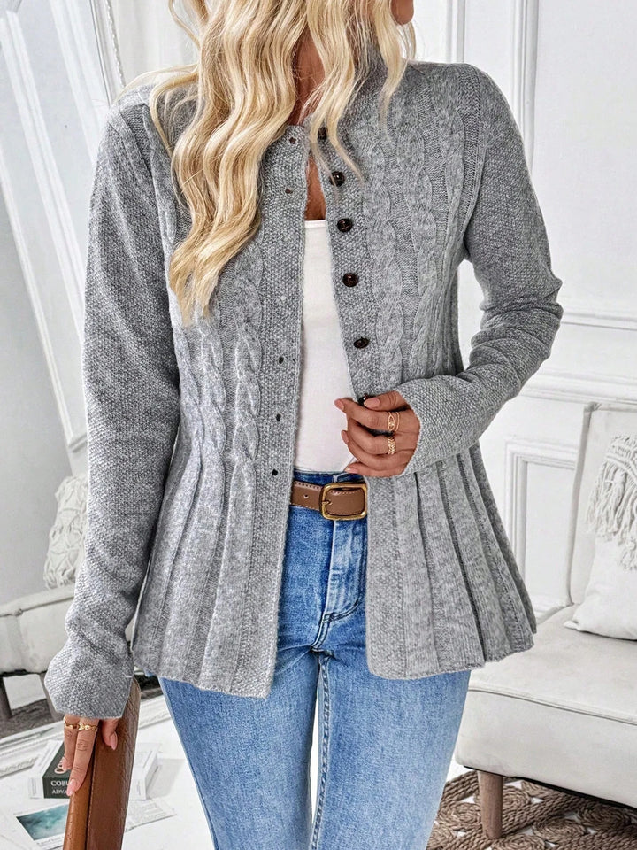 Woman wearing gray cable knit button front cardigan with pleated peplum hem