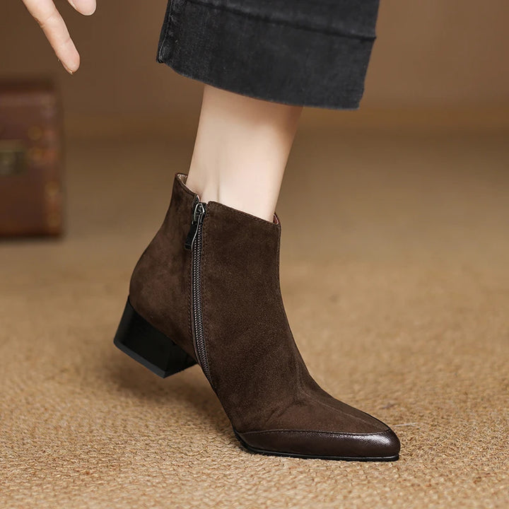 Model wearing brown suede pointed toe ankle boot with side zip