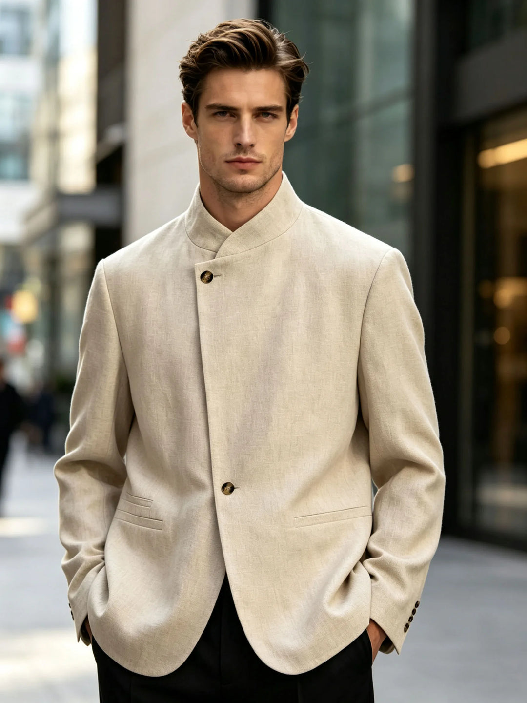 Man wearing beige mandarin collar blazer with black trousers