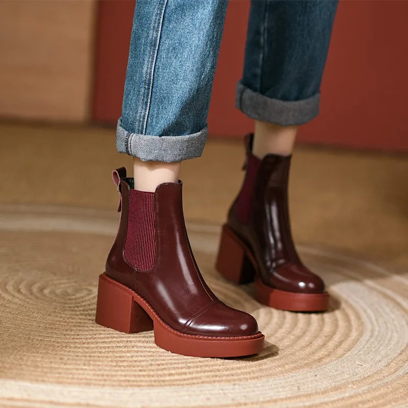 Model wearing wine red Chelsea boots with cuffed jeans