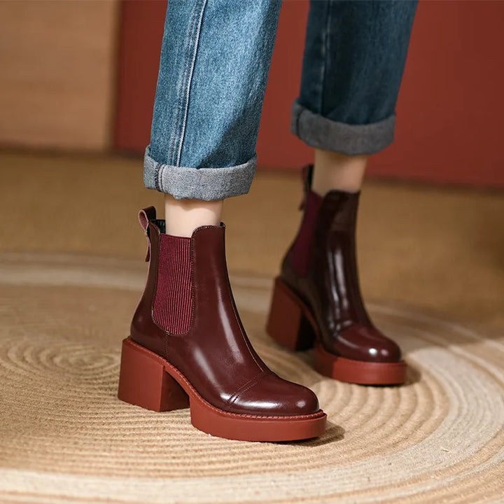 Model wearing wine red Chelsea boots with cuffed jeans