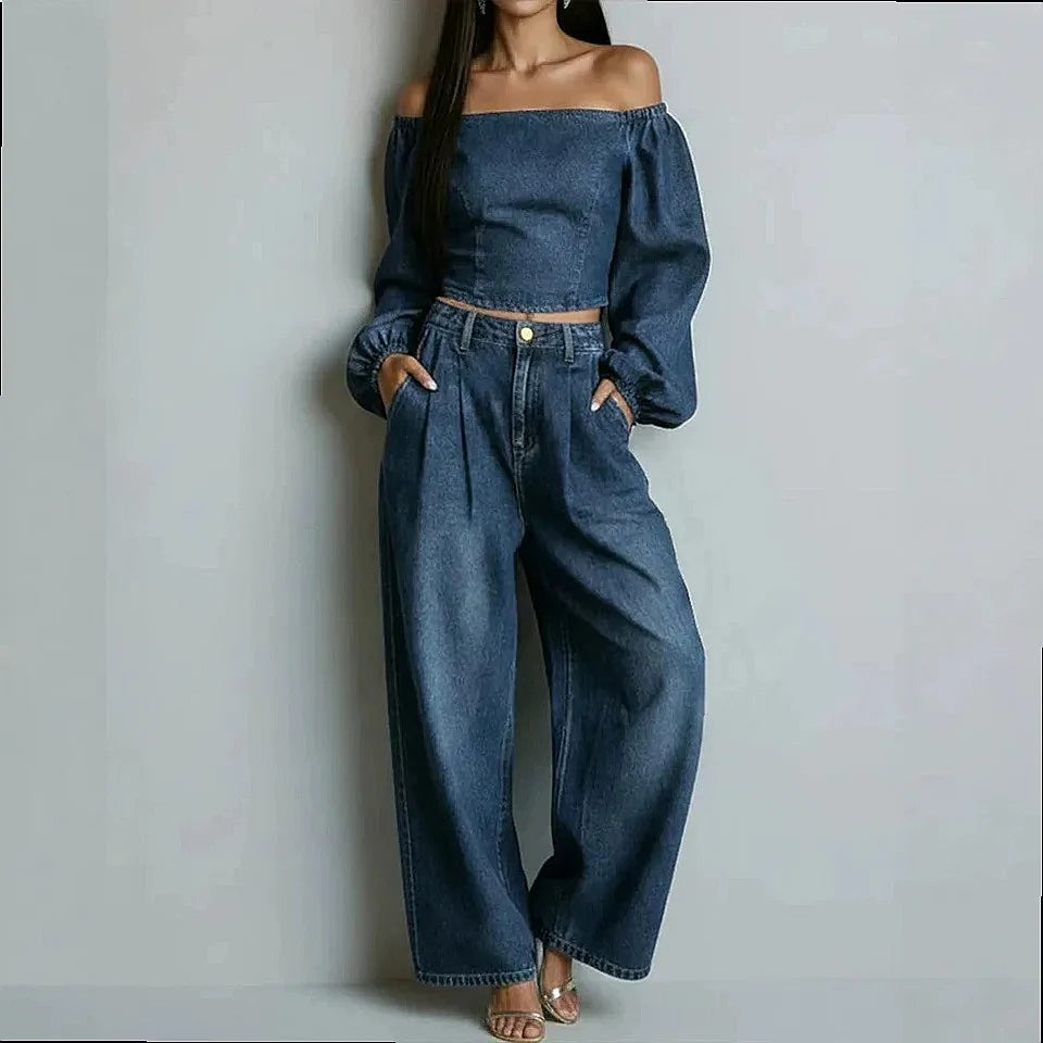 Woman wearing dark blue denim off-shoulder crop top and wide leg pants set, front view
