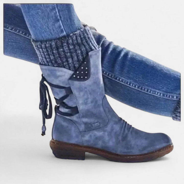Blue suede winter boot with knit cuff worn with jeans