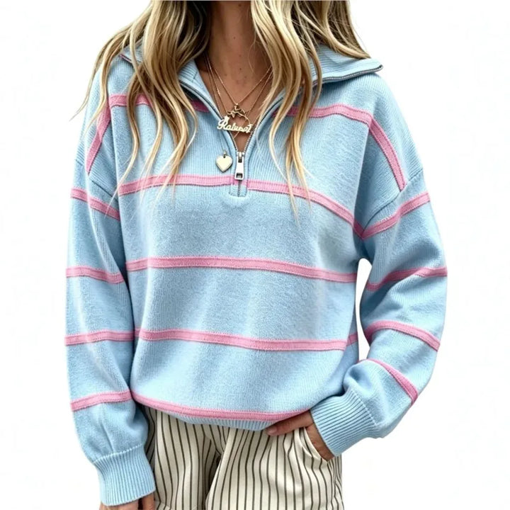 Woman wearing light blue striped quarter-zip sweater, close view