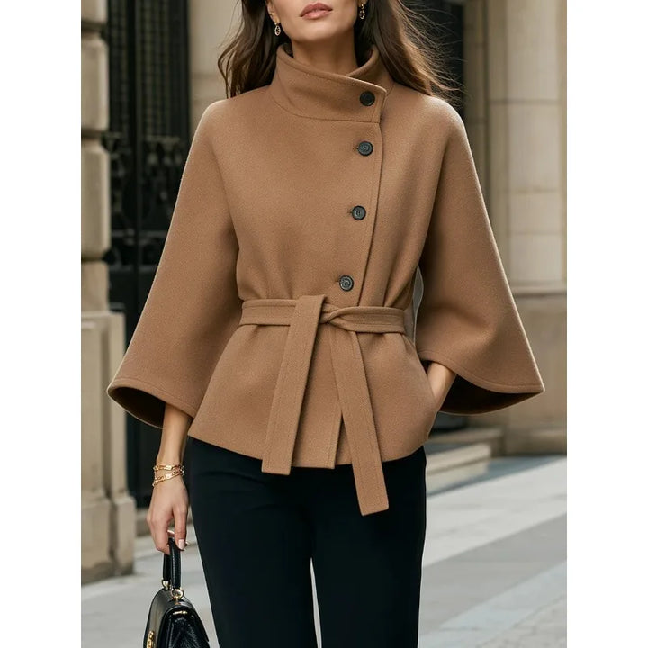 Close view of camel cape coat belted waist and buttons