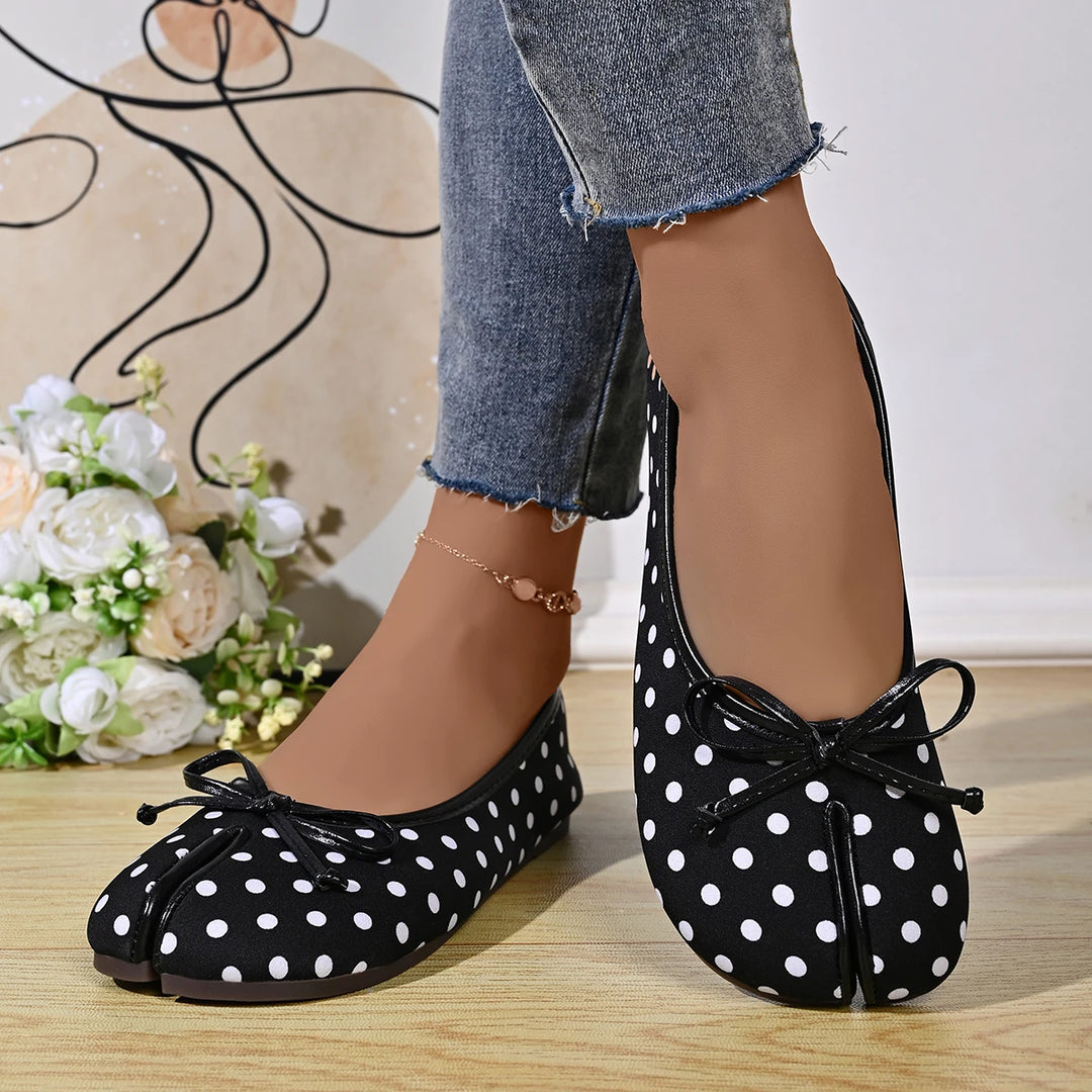 Model wearing black polka dot tabi ballet flats