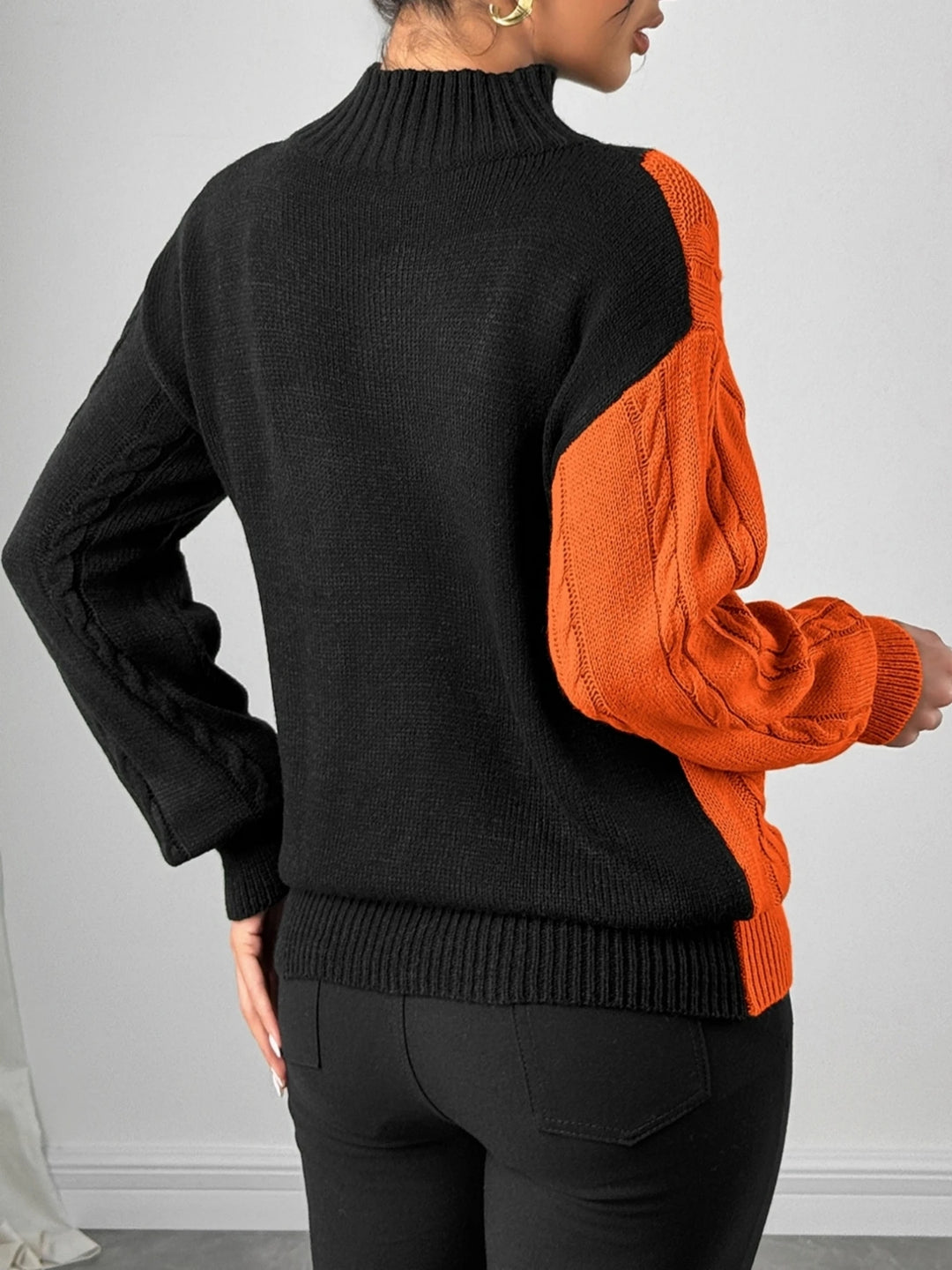 Orange and black color block cable knit sweater, back view