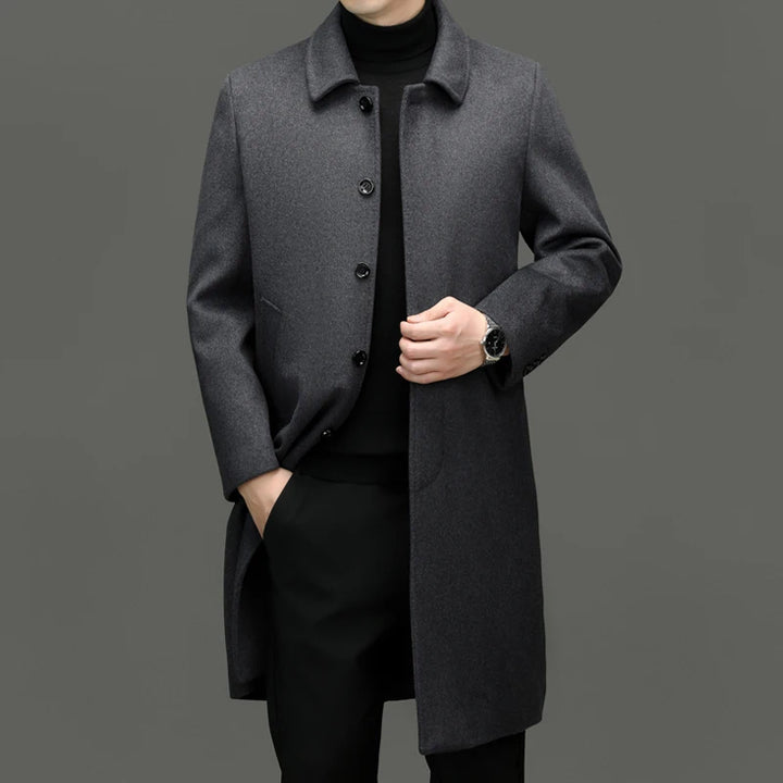 Man wearing grey wool coat, front view with hand in pocket