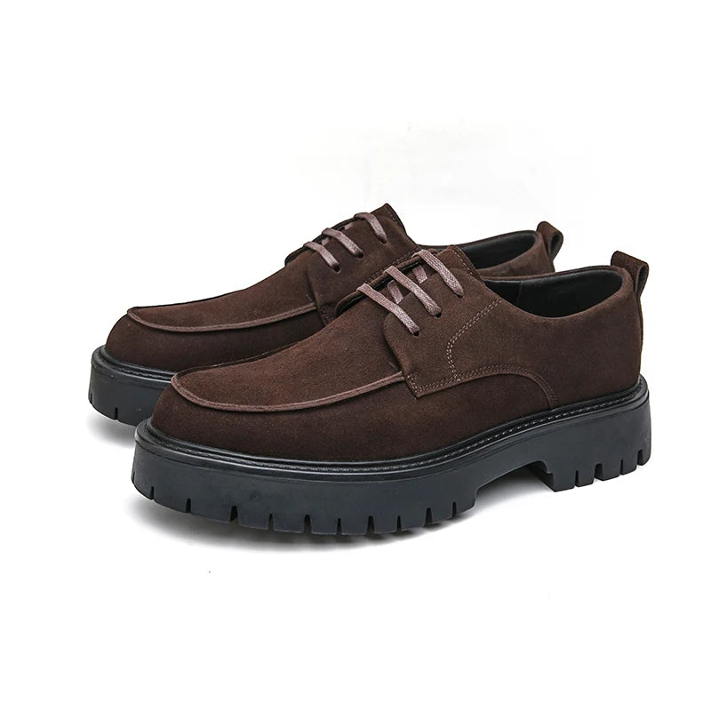 Pair of brown suede platform oxford shoes on white background