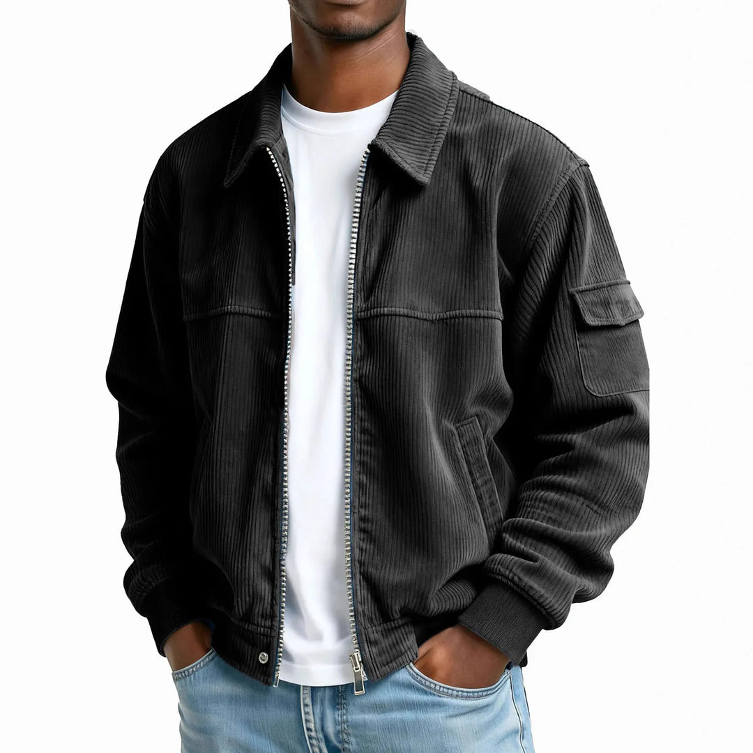 Man wearing black corduroy zip jacket with flap pocket