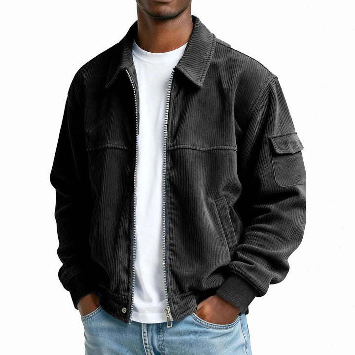 Man wearing black corduroy zip jacket with flap pocket