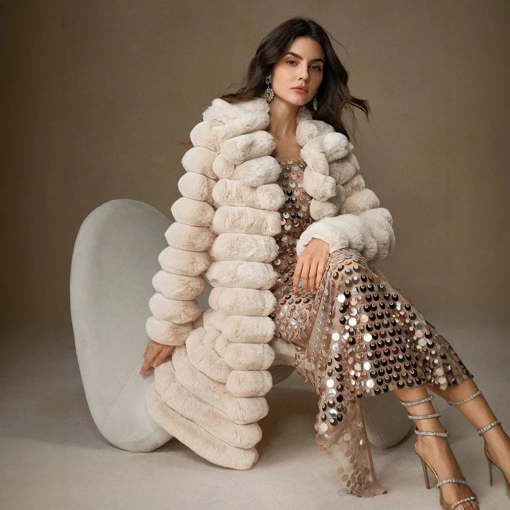 Seated model in light brown faux fur coat showing textured sleeve detail