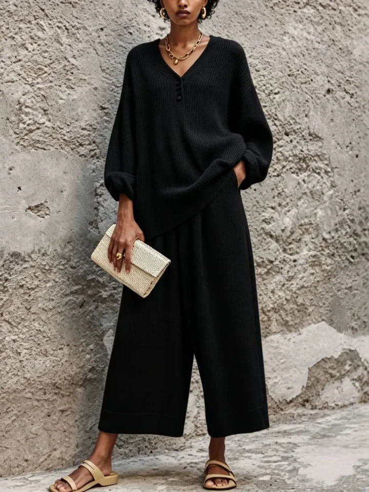 Woman wearing black ribbed knit sweater and wide leg pants set