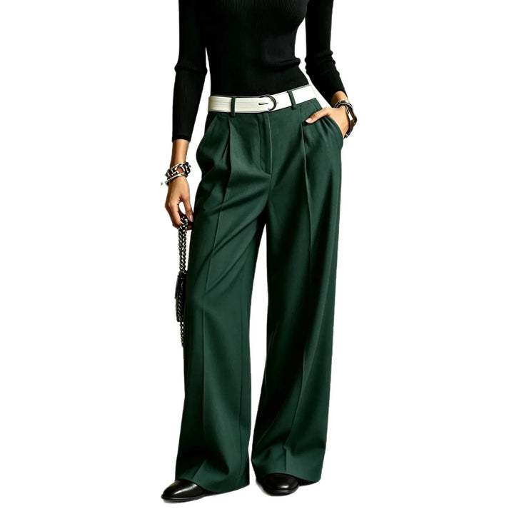 Dark green wide leg pleated trousers on plain background