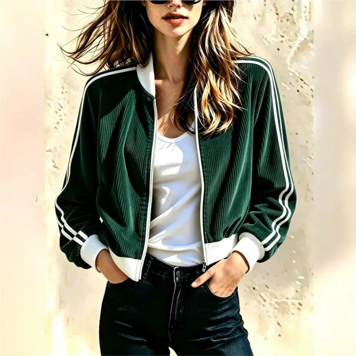 Woman wearing dark green corduroy bomber jacket with white stripe trim