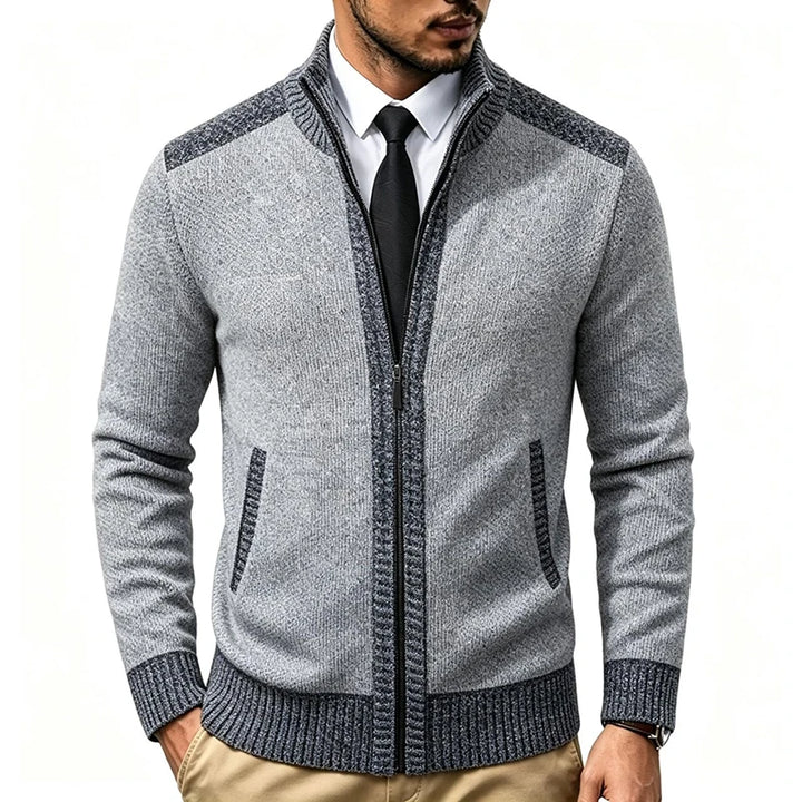 Man wearing light grey zip-up knit cardigan with dark trim, front view