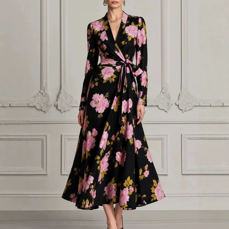 Woman wearing black floral wrap dress with tie waist, front view