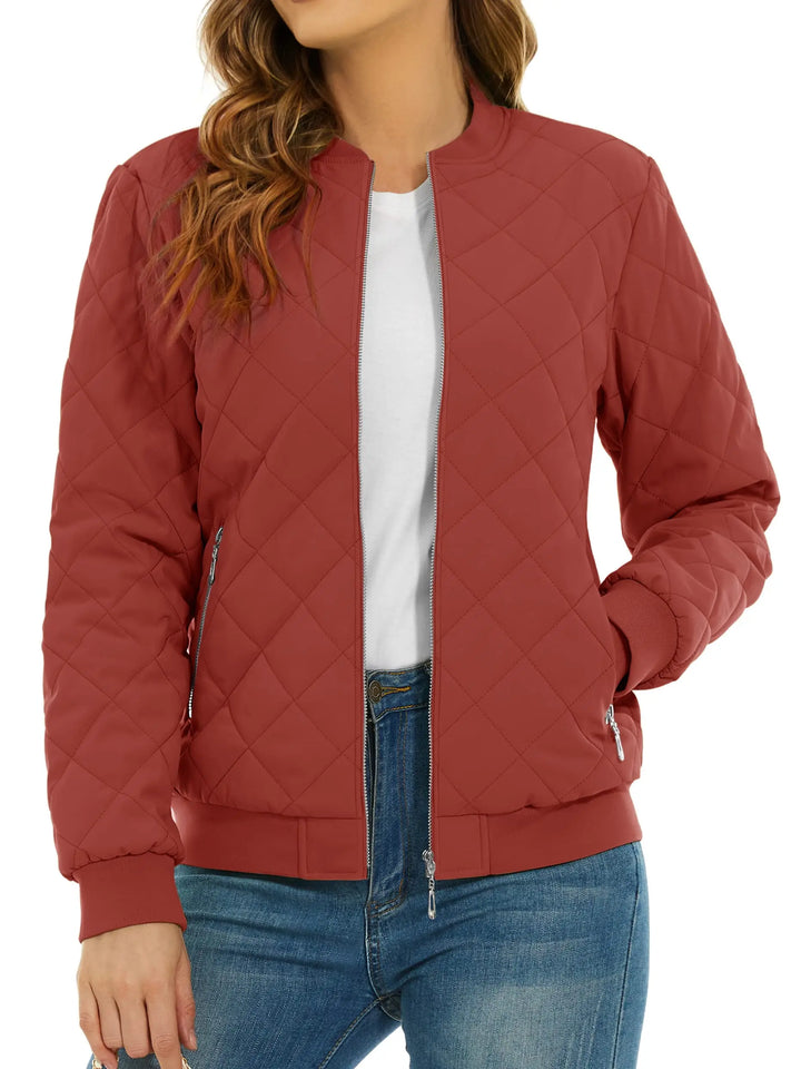 Close up of orange red quilted bomber jacket with zip pocket
