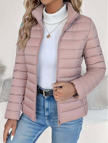 Woman wearing pink quilted puffer jacket with stand collar, zipped open