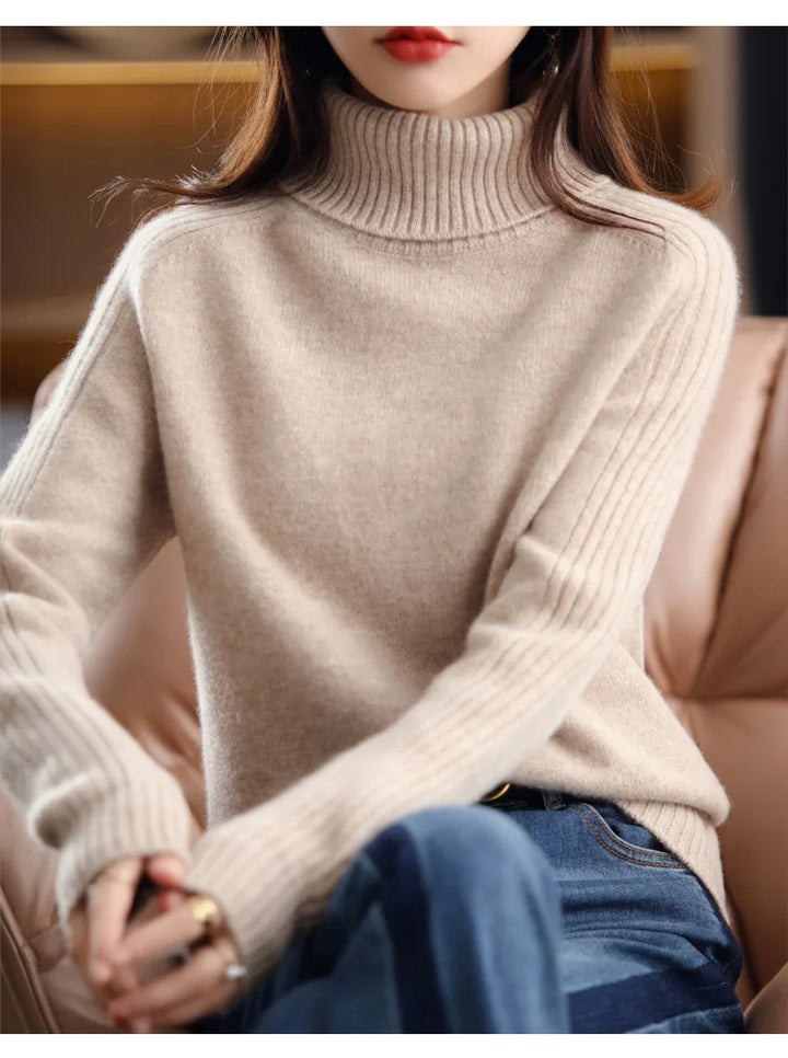 Beige ribbed turtleneck knit sweater, front view seated