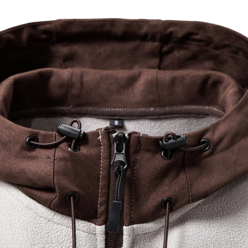 Close up of hood drawstring and zipper detail on fleece jacket