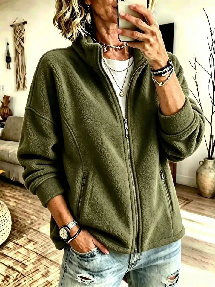 Woman wearing army green fleece full zip jacket with stand collar