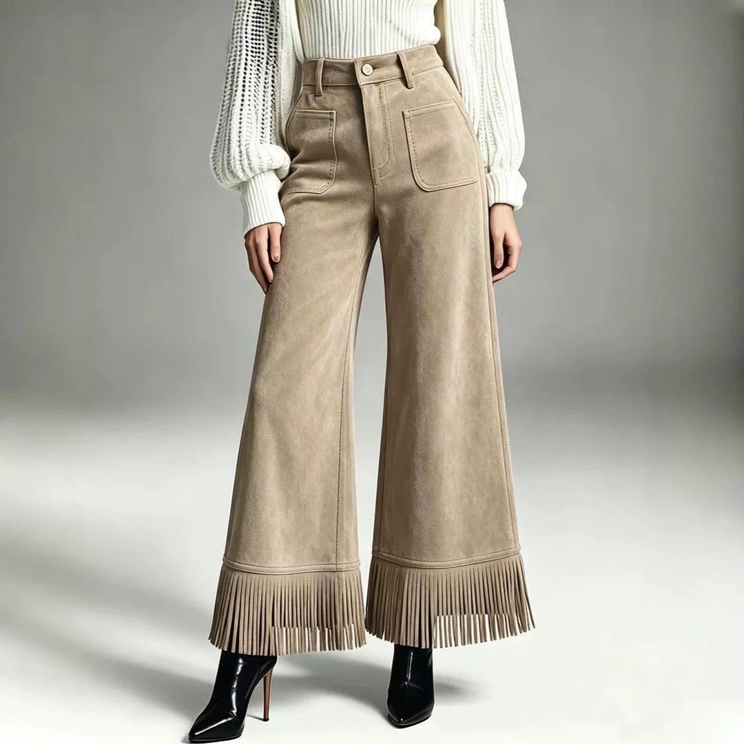Woman wearing apricot suede-look flare pants with fringe hem, front view