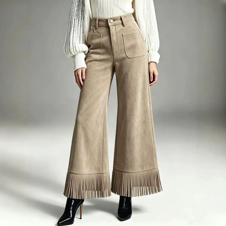 Woman wearing apricot suede-look flare pants with fringe hem, front view