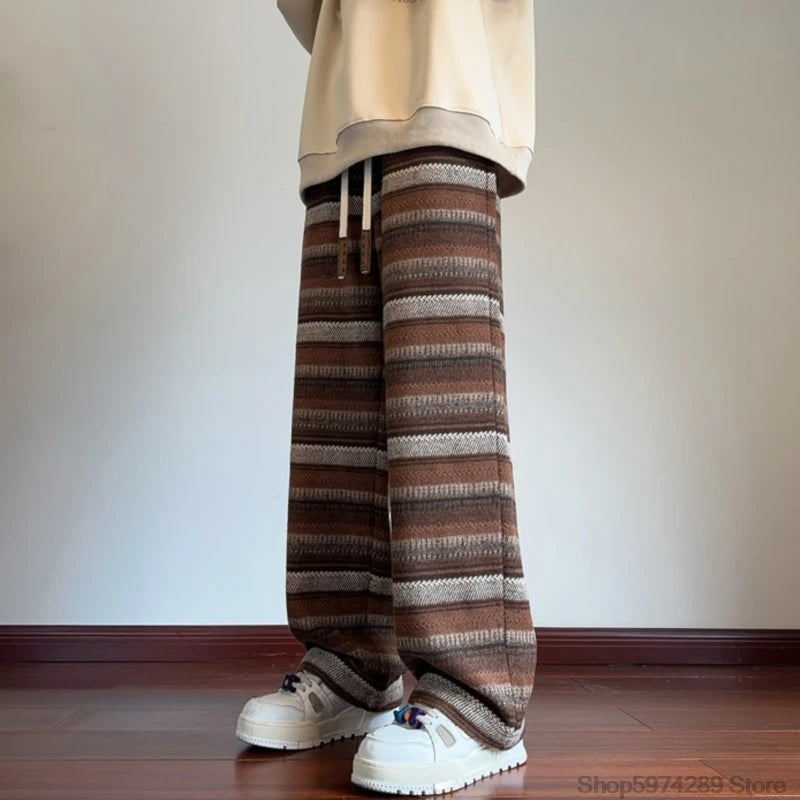 Man wearing coffee striped wide leg pants with drawstring waist, front view