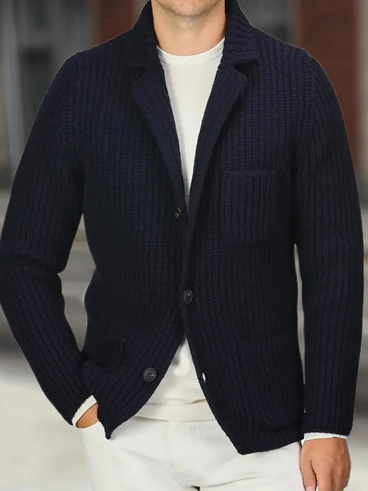 Close view of navy knit cardigan lapel and button closure