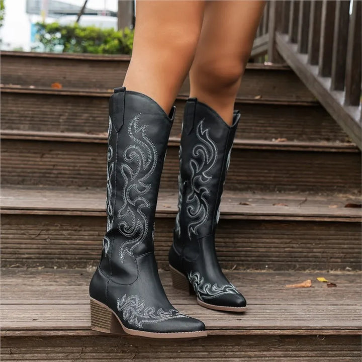 Black embroidered cowboy boots front view on steps