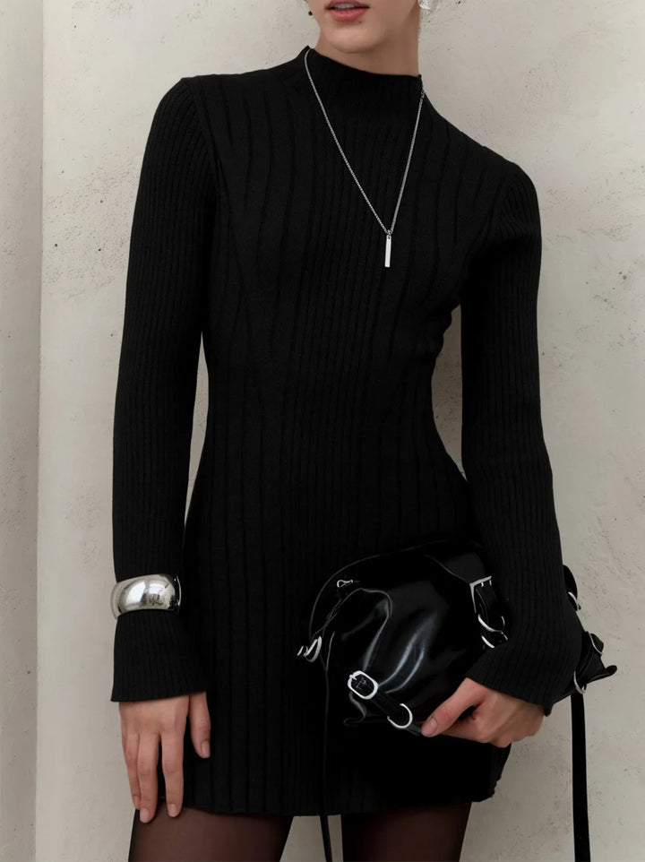 Black ribbed knit sweater dress with silver cuff accessory