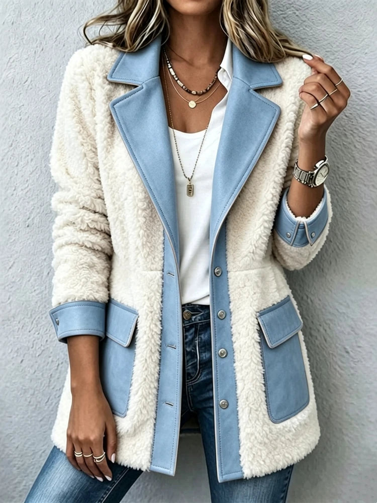 Woman wearing blue two-tone sherpa fleece jacket with faux suede trim, front view