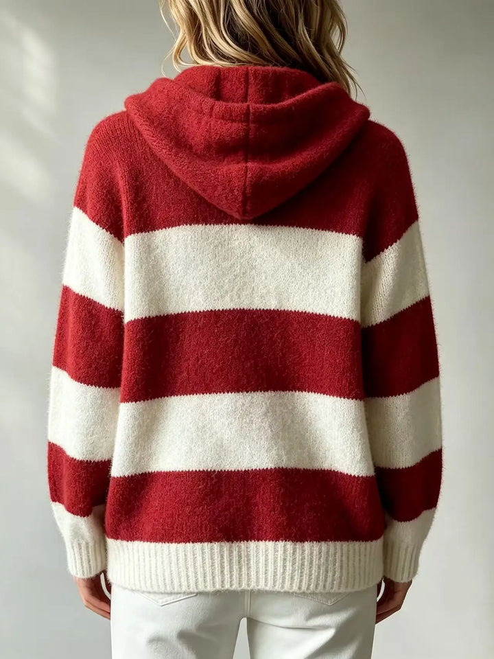 Back view of striped hooded knit sweater showing hood and ribbed hem
