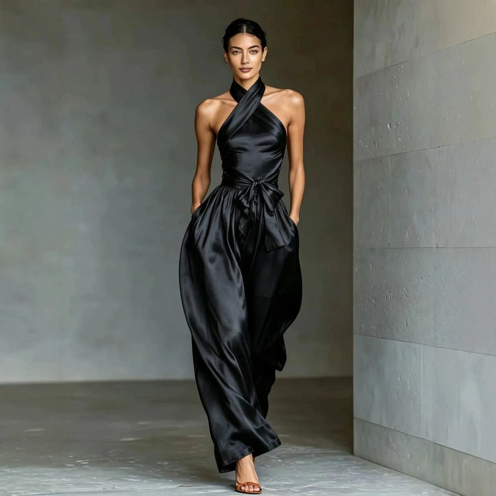 Black satin halter jumpsuit with crossed neckline and wide leg