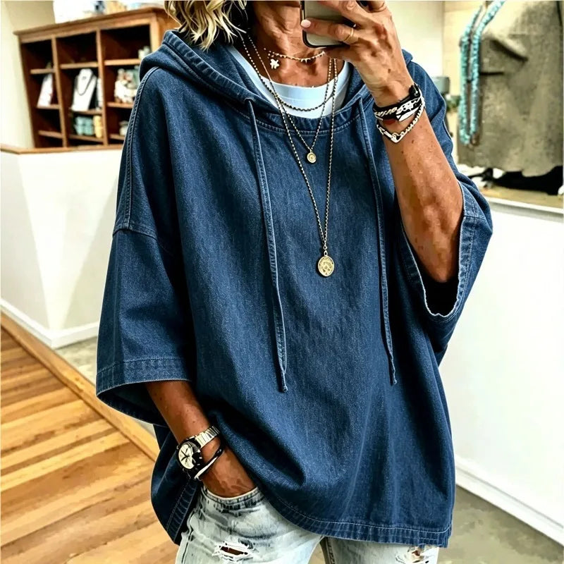 Woman wearing oversized deep blue denim hoodie with drawstring hood