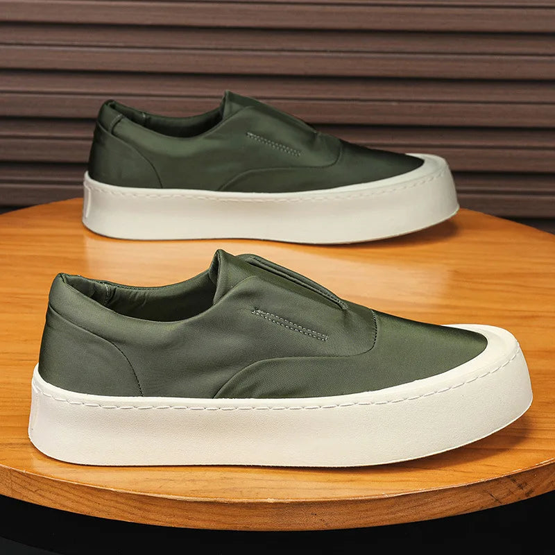 Green canvas slip-on sneakers side profile pair