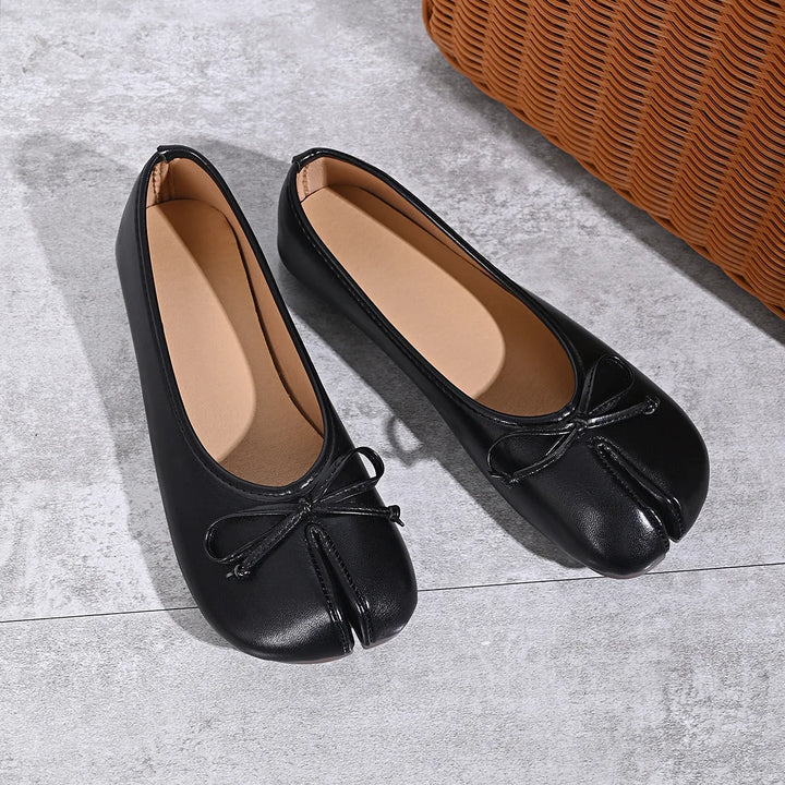 Black faux leather tabi ballet flats angled view