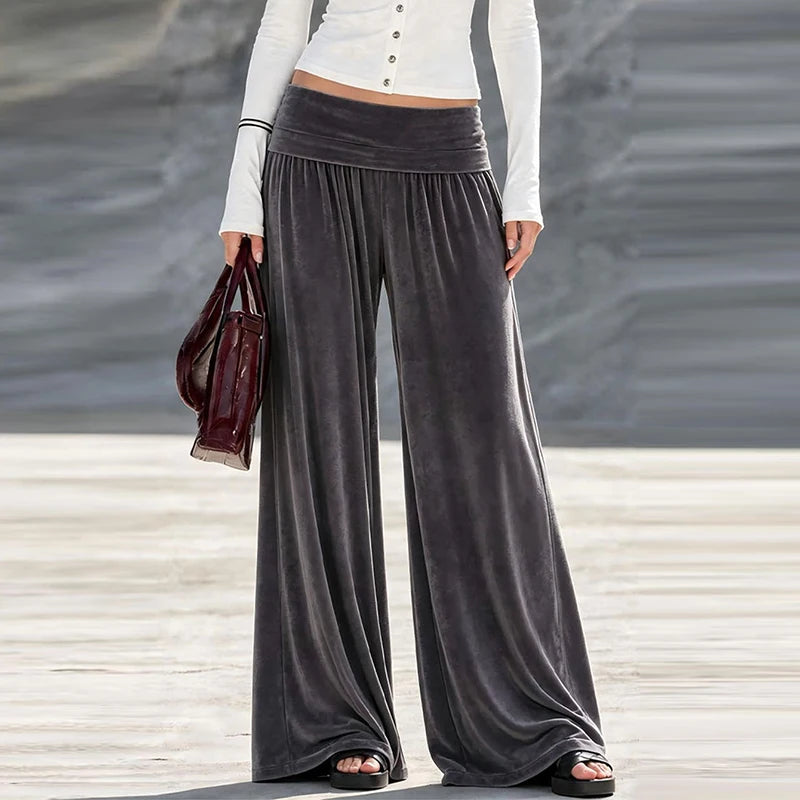 Woman wearing charcoal grey velvet wide leg high waist pants, front view