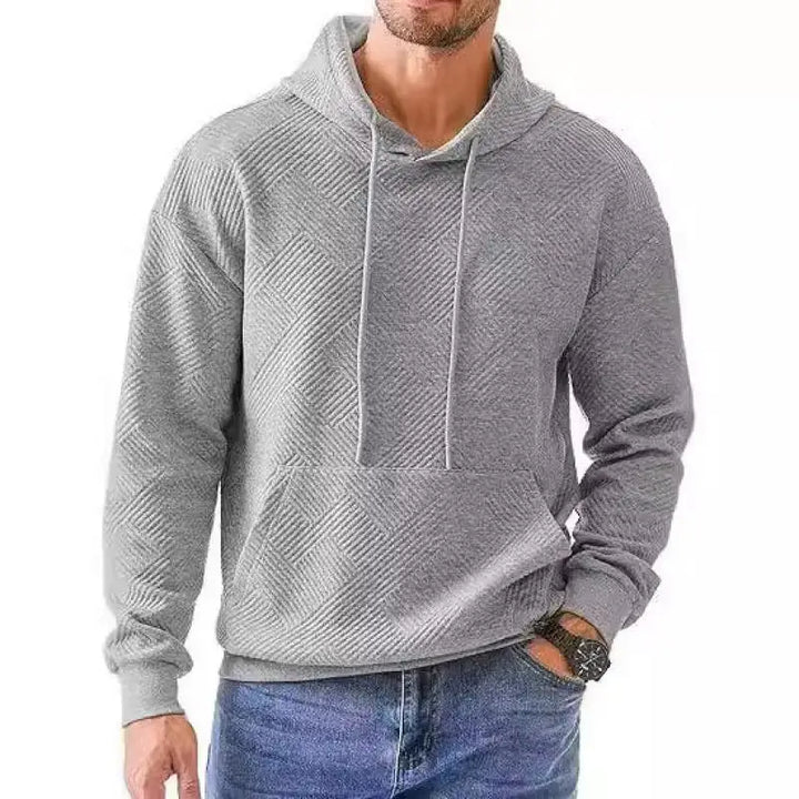 Man wearing grey textured knit pullover hoodie