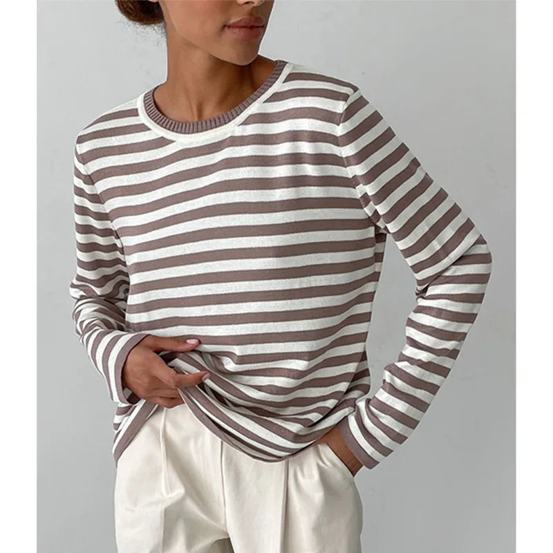 Woman wearing brown and white striped knit sweater